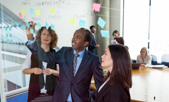 MBA students at whiteboard