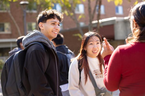 Hamline student in group listening to two other students