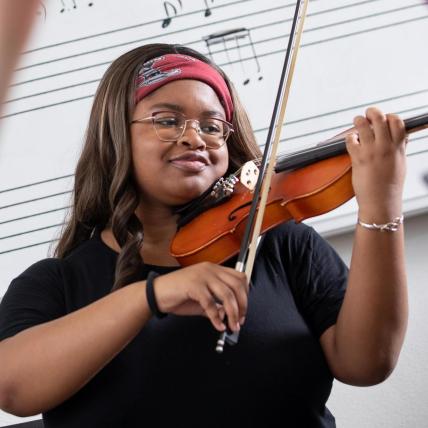 Homepage -- student playing violin