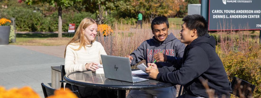 Three students sitting in front of GLC