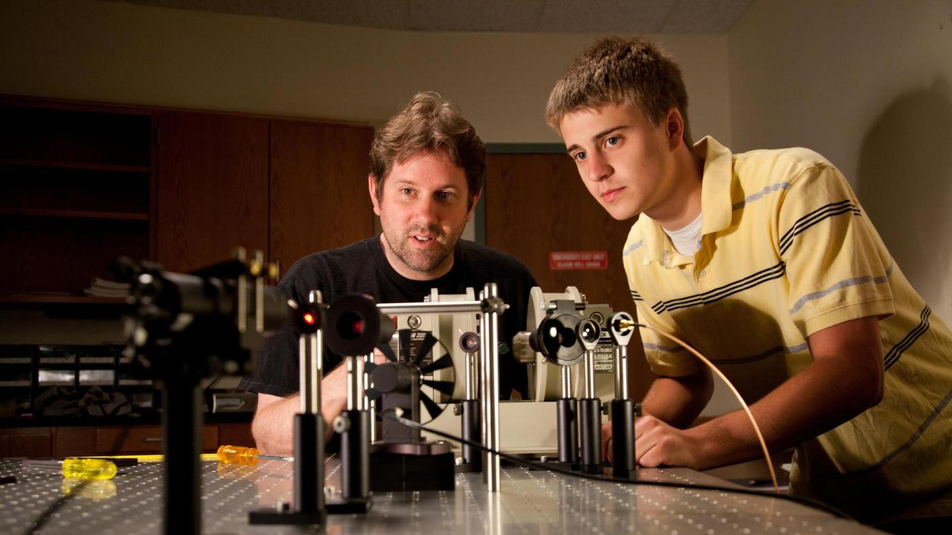 Two people working on an engineering project together at a table