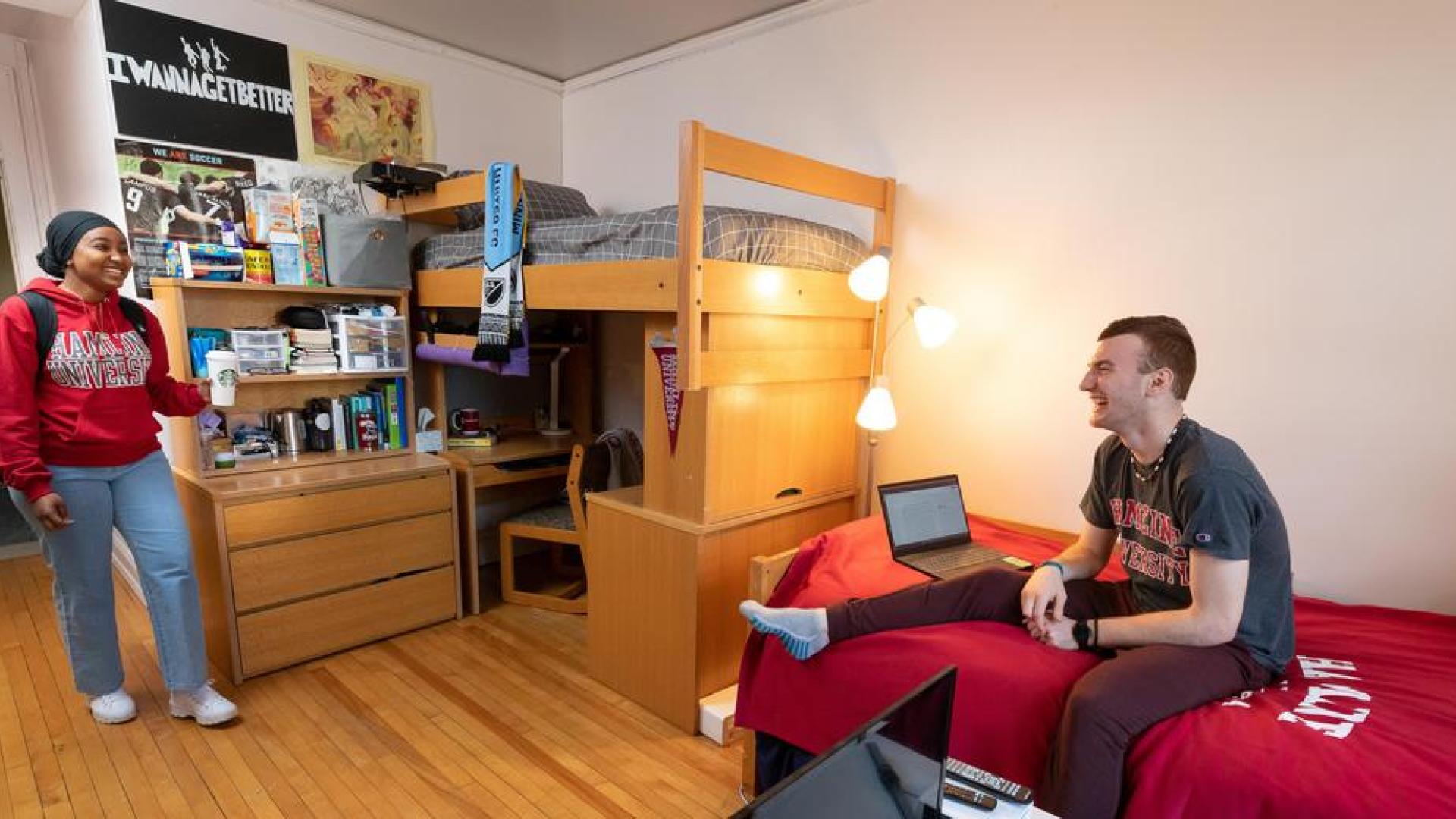 Two Hamline students talking in a Hamline dorm room