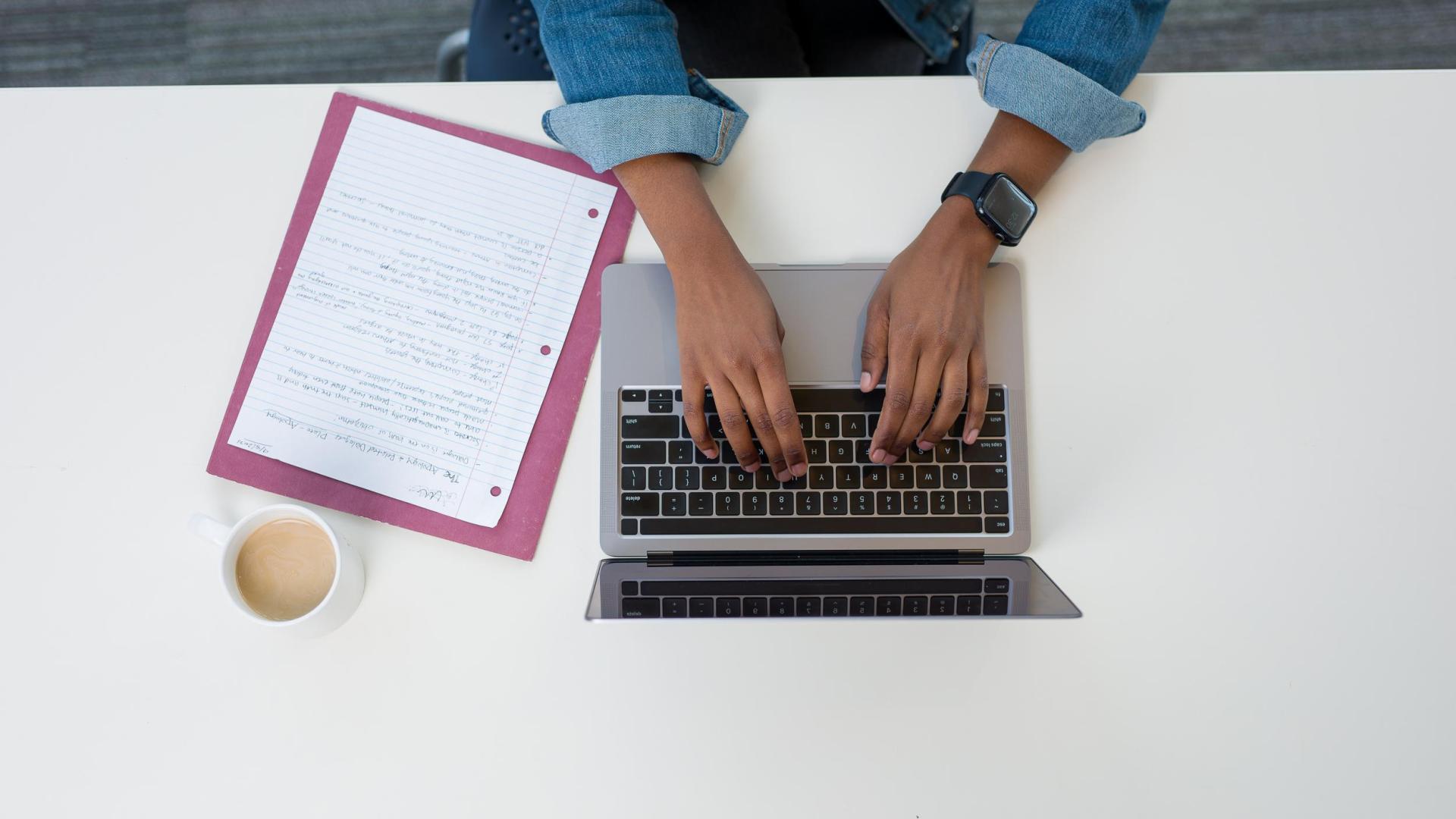 Hands typing on computer