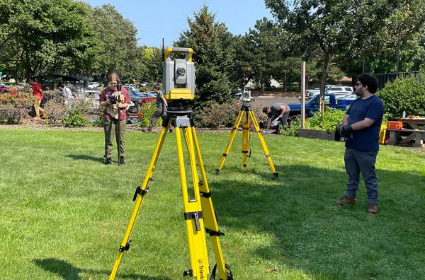 Students in ANTH 3810 practice surveying techniques using a total station and theodolite.