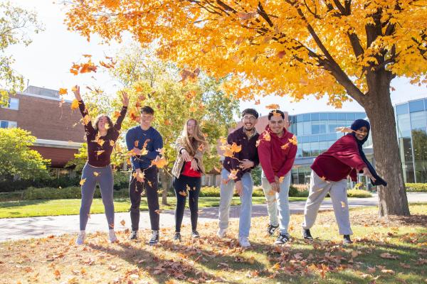 Students throwing leaves